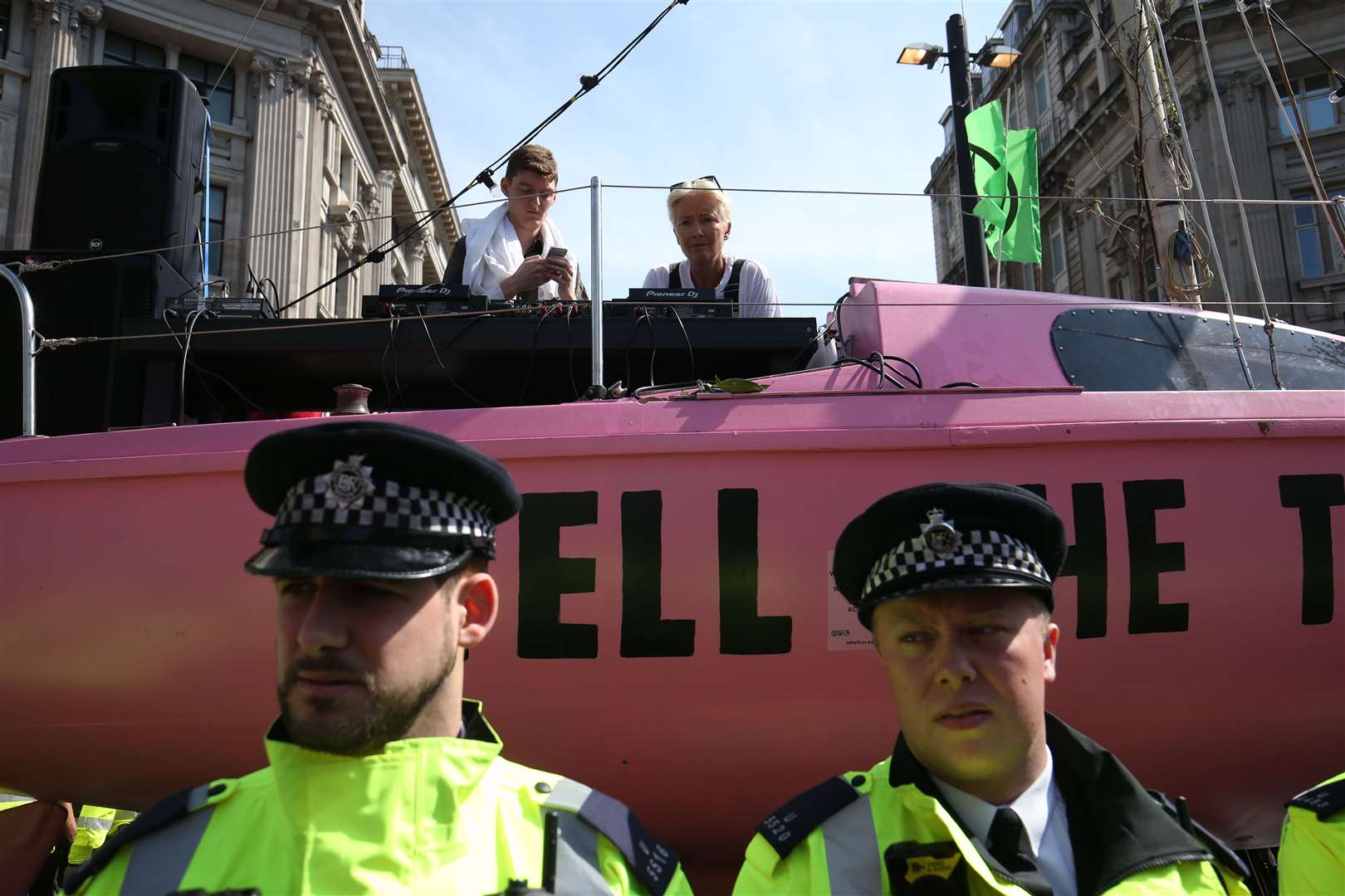 Police surround an Extinction Rebellion boat at an earlier street protest (PA)