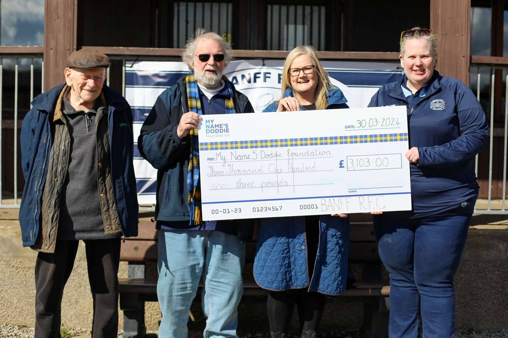 Former club president Bob Philips presented the cheque for £3,103 to My Name’5 Doddie Foundation volunteer Morven Mackenzie. Picture: Annie Rees