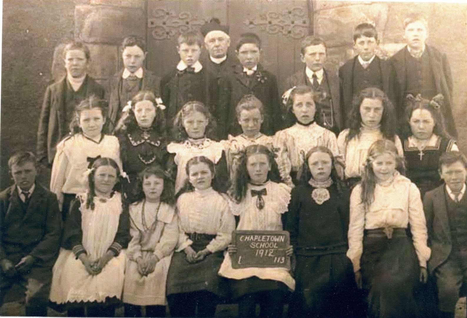 Chapeltown School pupils pictured with a priest during 1912 in front of the Our Lady of Perpetual Succour, the remote and beautiful Catholic Church at Chapeltown. Credit: M Hogg / Tomintoul & Glenlivet Digital Archive.