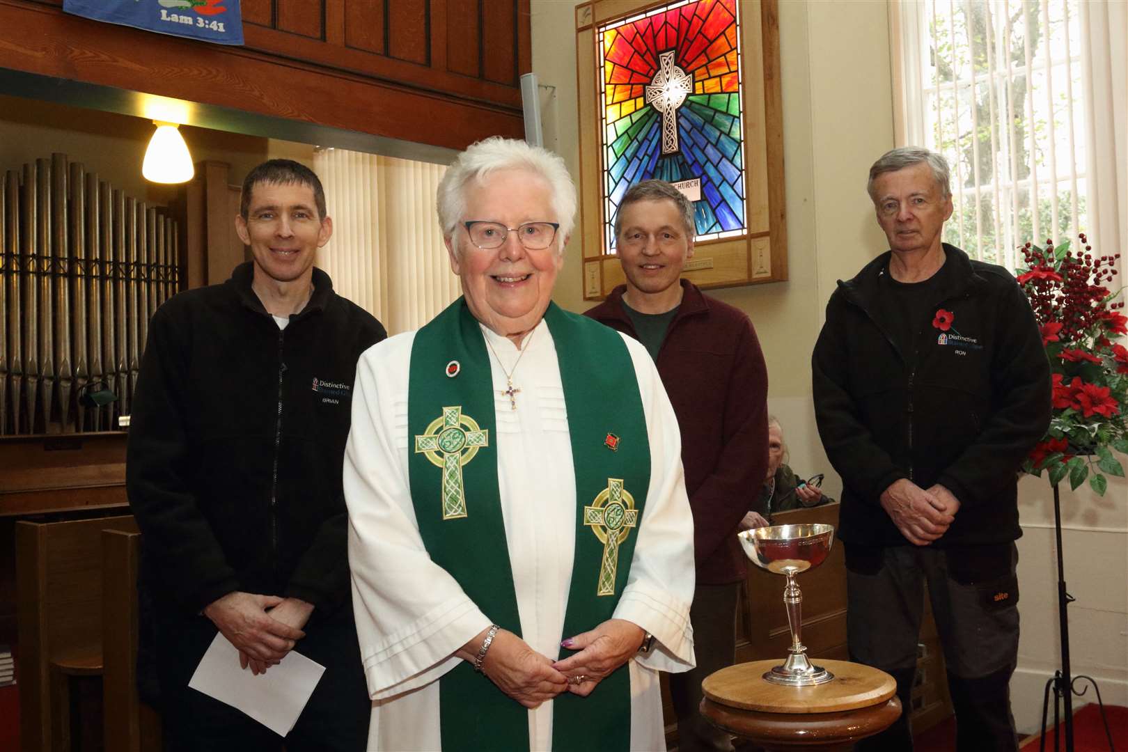 Rev Sheila Craggs, with Brian Innes, Graham Winram and Ron Innes who created the wiindow.