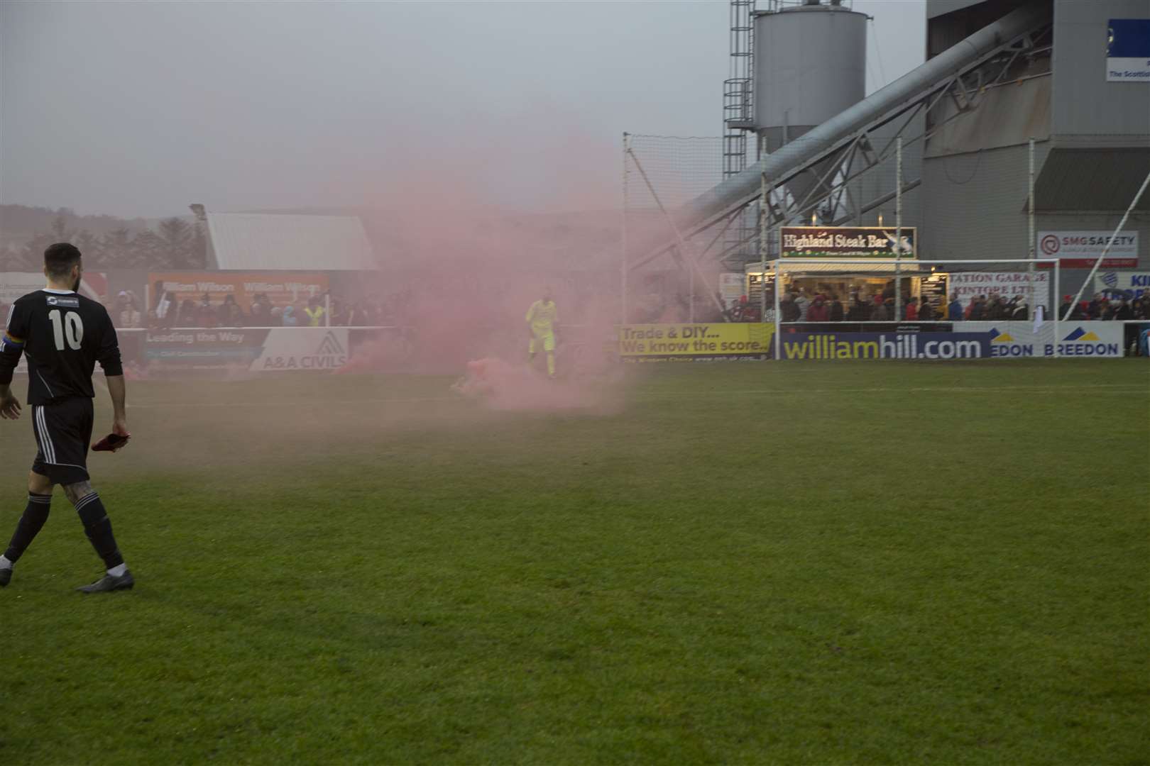 Broxburn fans delay kick-off by throwing smoke bombs onto the turf. Picture: Paul Douglas