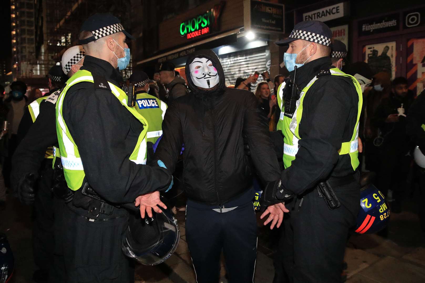Police detain a protester (Aaron Chown/PA)