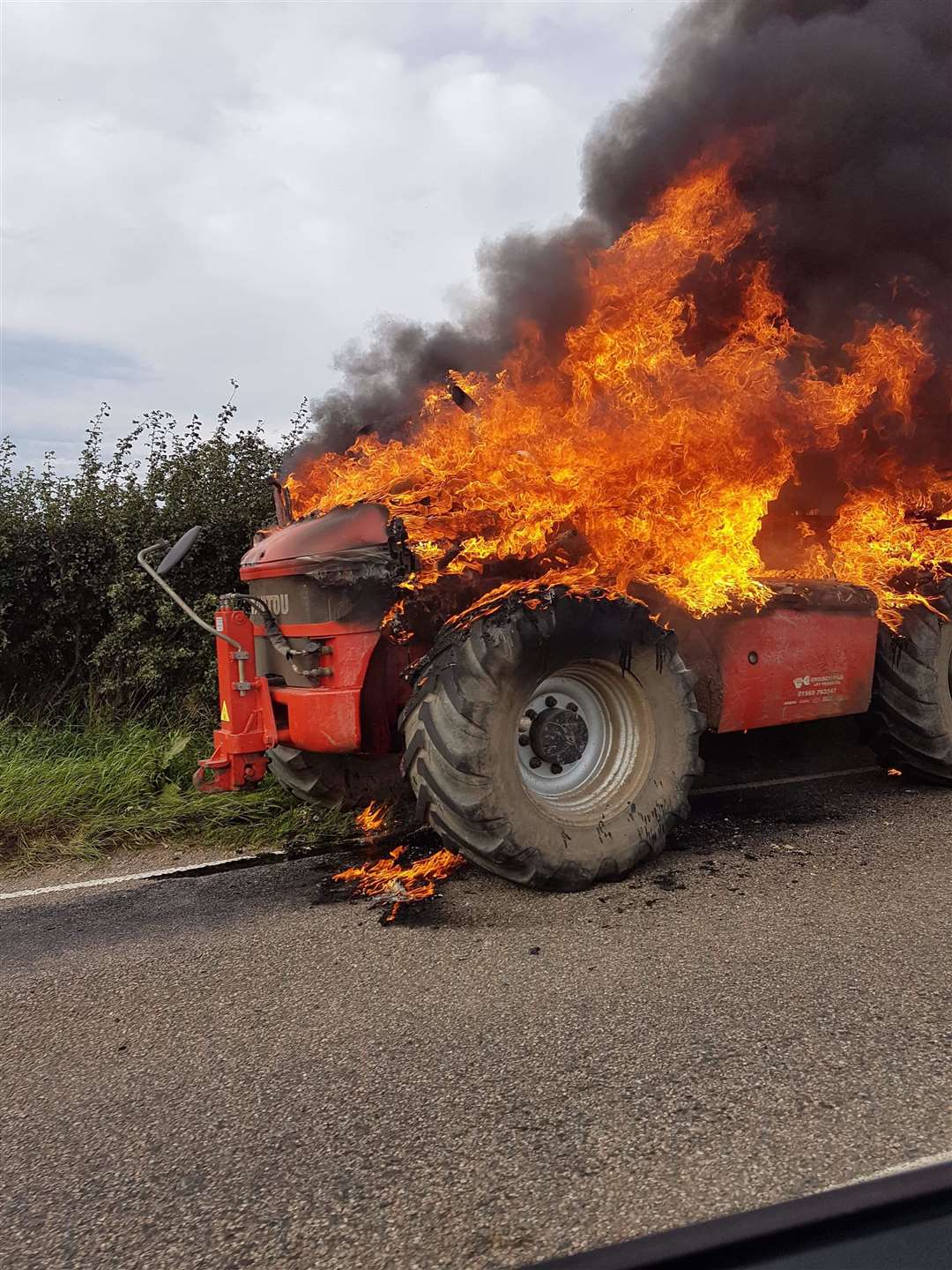 Flames ravage the tractor prior to the arrival of the fire service. Picture: SPP
