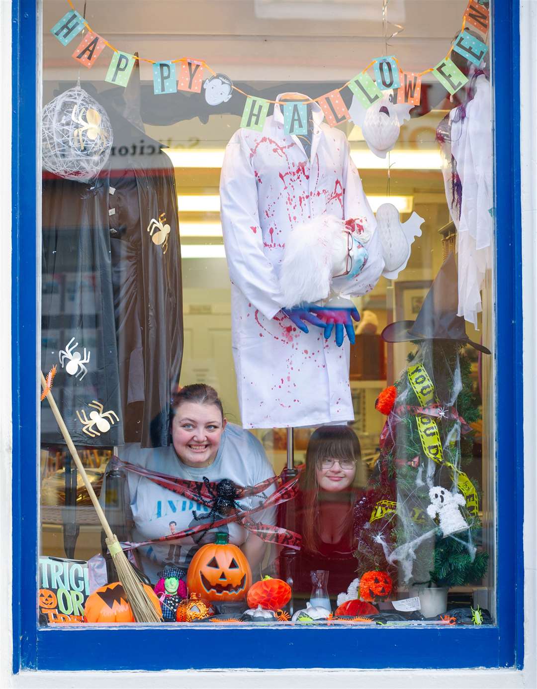 Zara Taylor (left) and Emma Duncan peep through the Inspire By Huntly Halloween window display. Picture: Daniel Forsyth..