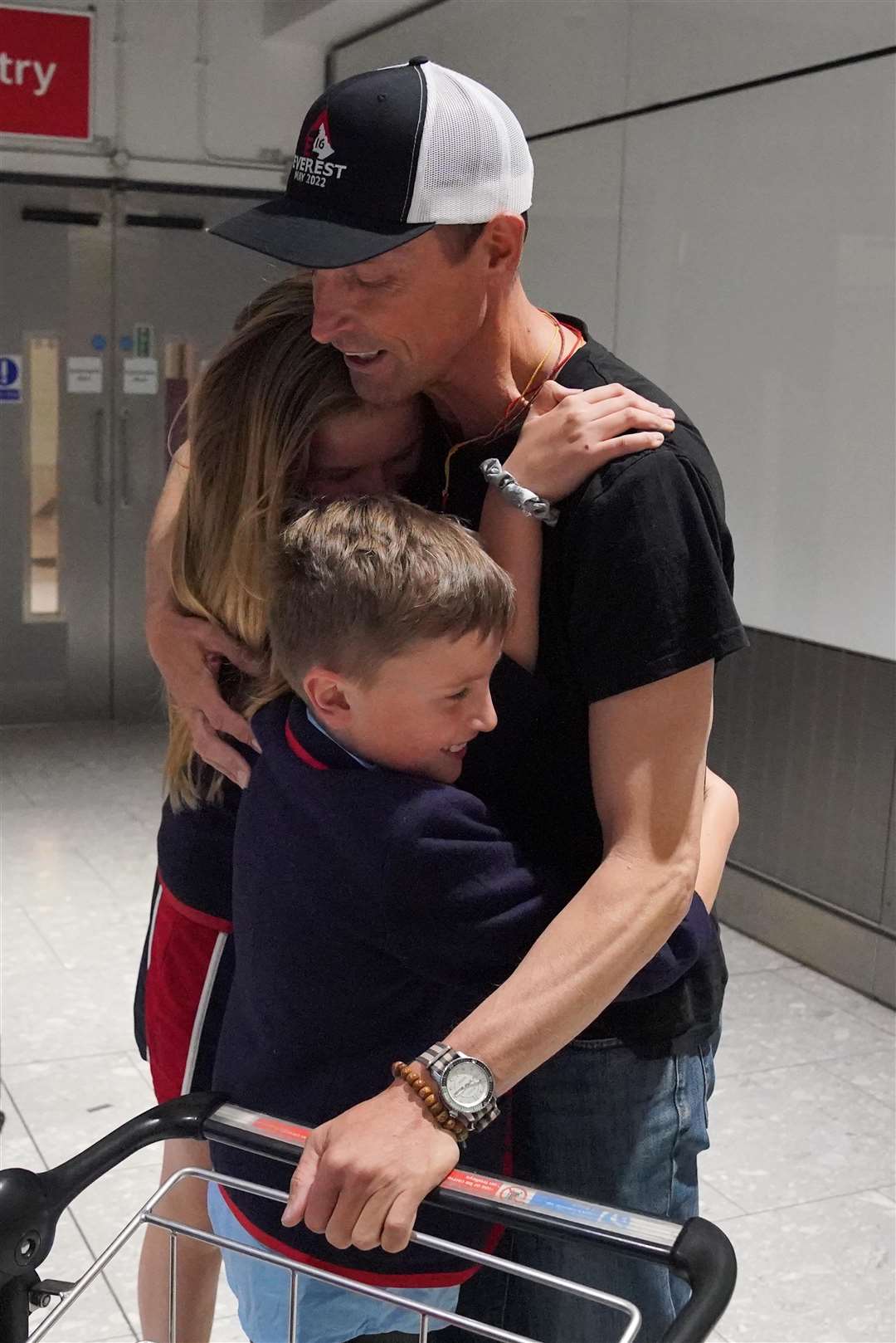 Kenton Cool was embraced by daughter Saffron and son Willoughby at Heathrow Airport (Jonathan Brady/PA)