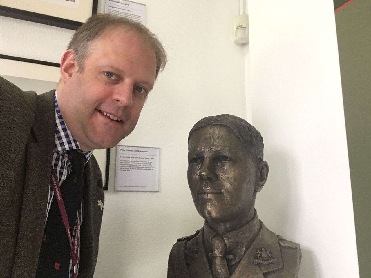 With a bust of Neil Owen.