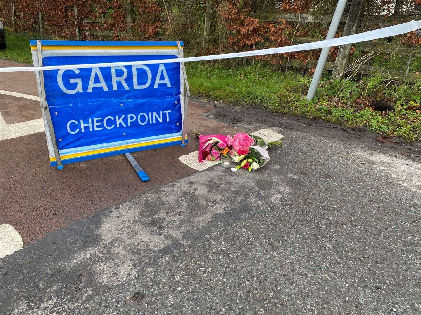 Flowers at a Garda checkpoint after the primary school teacher’s death (Dominic McGrath/PA)