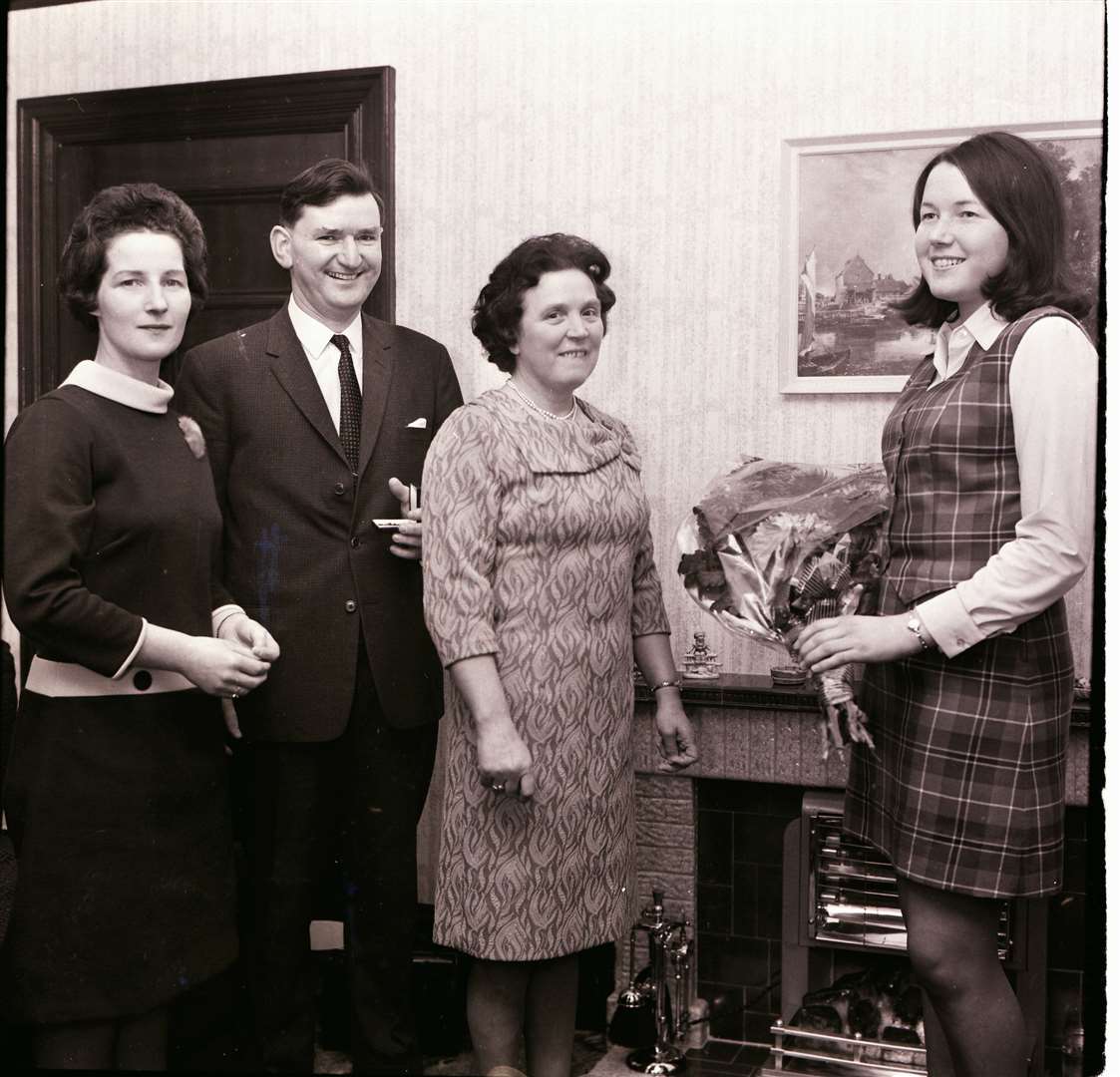 Nan Morrow is presented with flowers at Buckie Clydesdale Bank on the occasion of her husband, who is looking on, taking up the manager's post at the Lossiemouth branch on 1969.