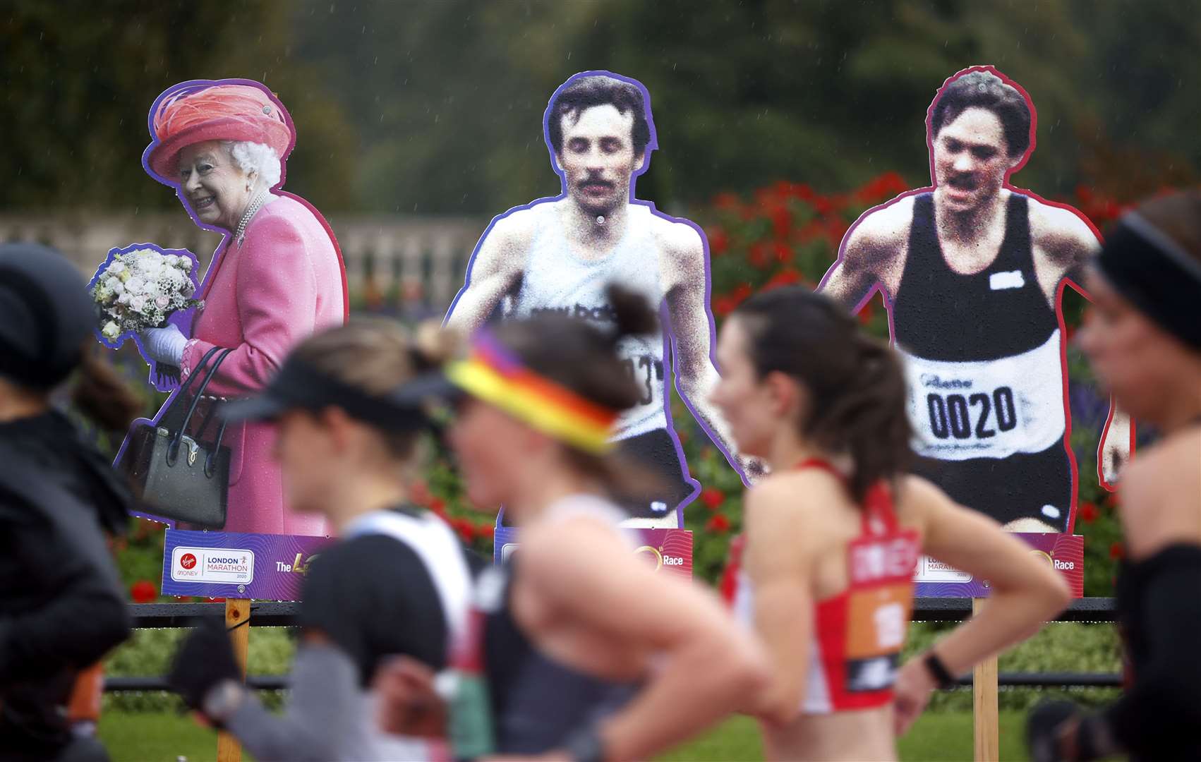 Cardboard cut-outs stood in for the usual crowds lining the marathon route – among them former competitors and the Queen (John Sibley/PA)