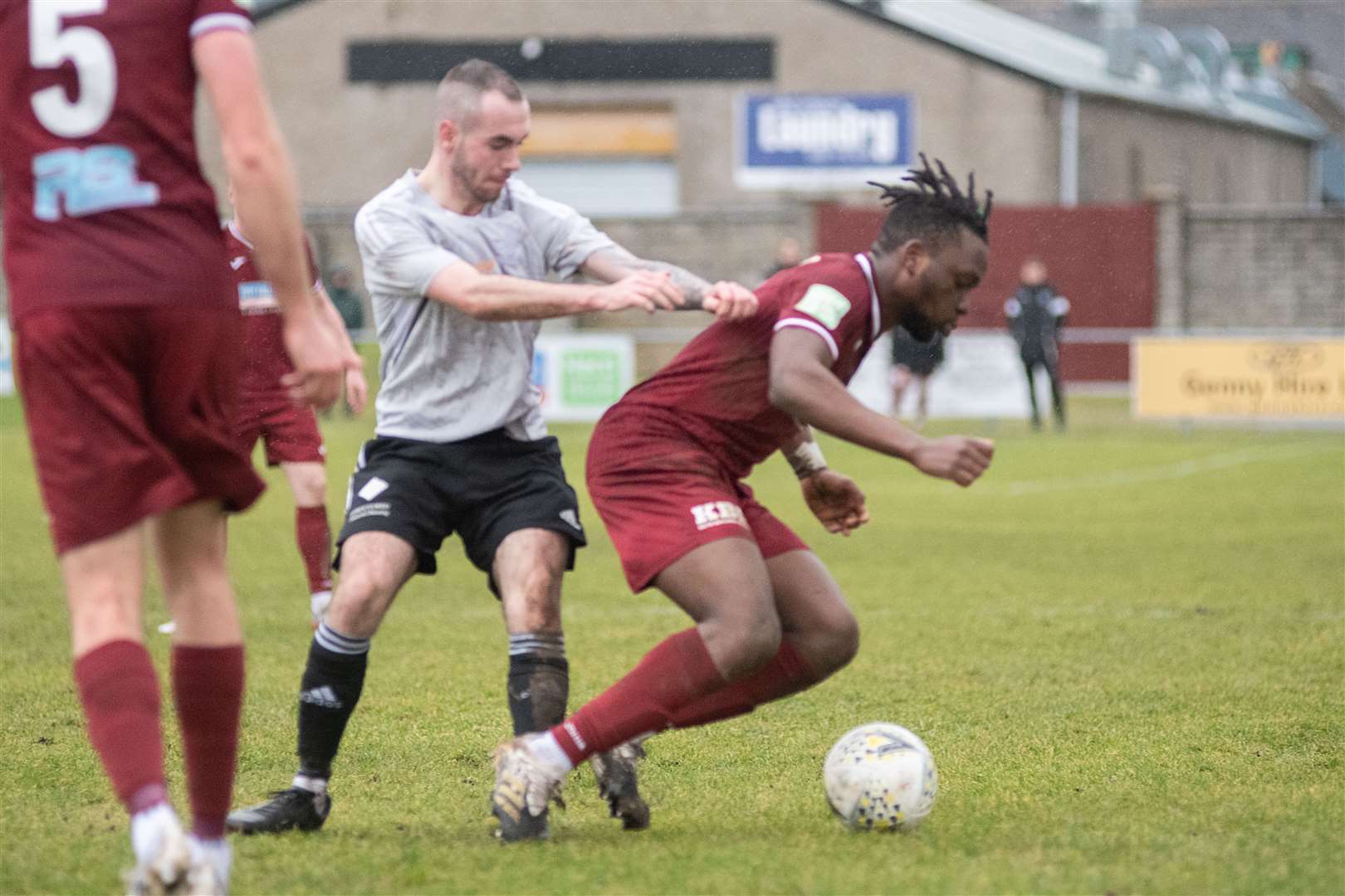 Deveronvale's Zane Laird barges Keith forward Demilade Yunus to the ground. ..Keith FC (1) vs Deveronvale FC (1) - Highland Football League 22/23 - Kynoch Park, Keith 04/02/23...Picture: Daniel Forsyth..