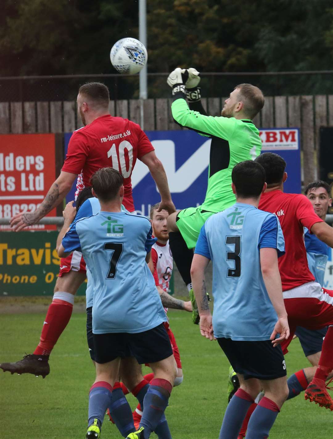 United captain Fraser Hobday clears one in the box.