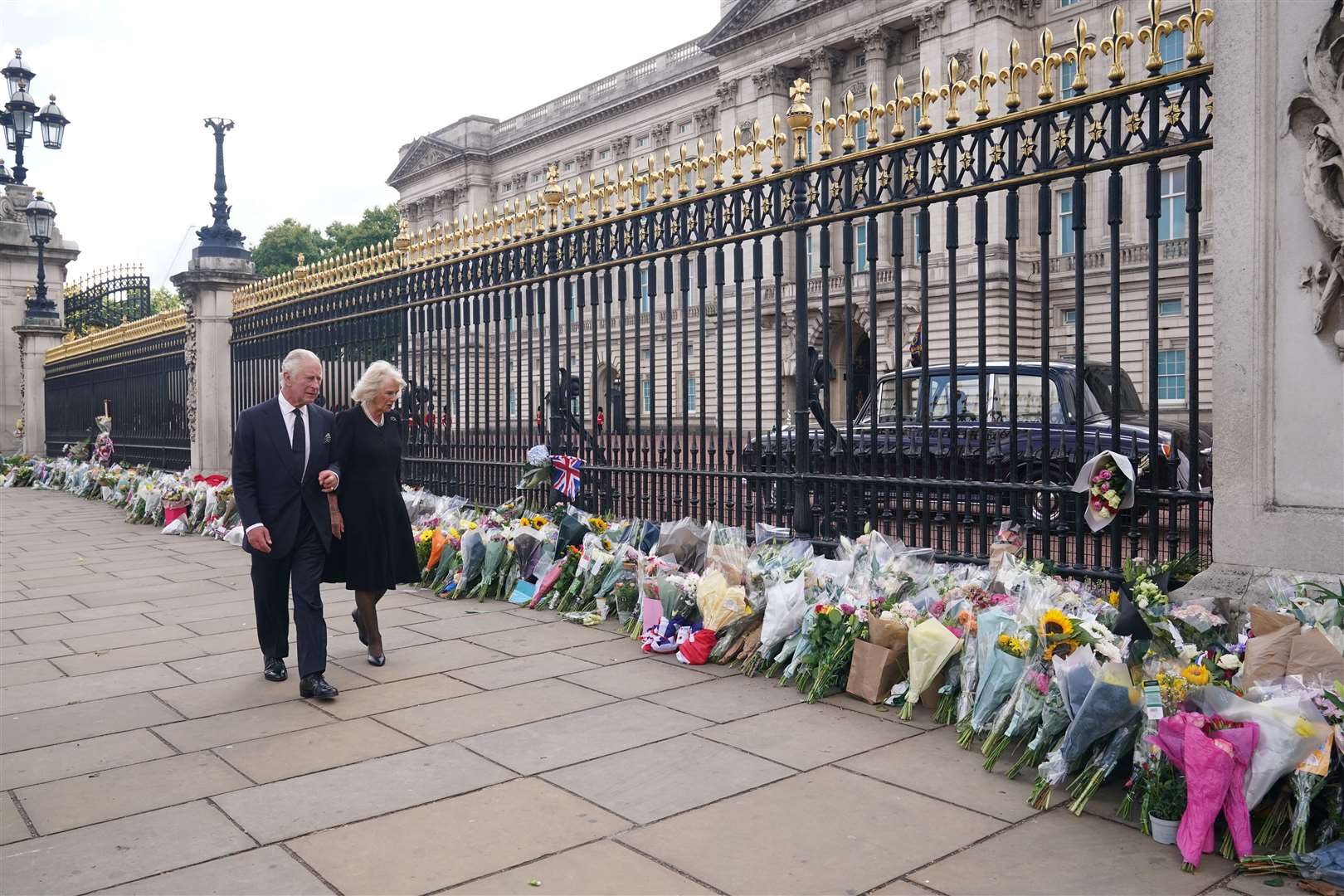 King Charles III and the Queen view tributes left outside Buckingham Palace (Yui Mok/PA)