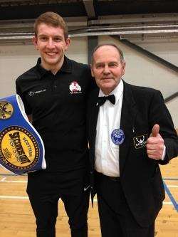 Scott Edwards, with his new Scottish title belt, celebrates with international boxing official and Elgin ABC founder Donald Campbell.