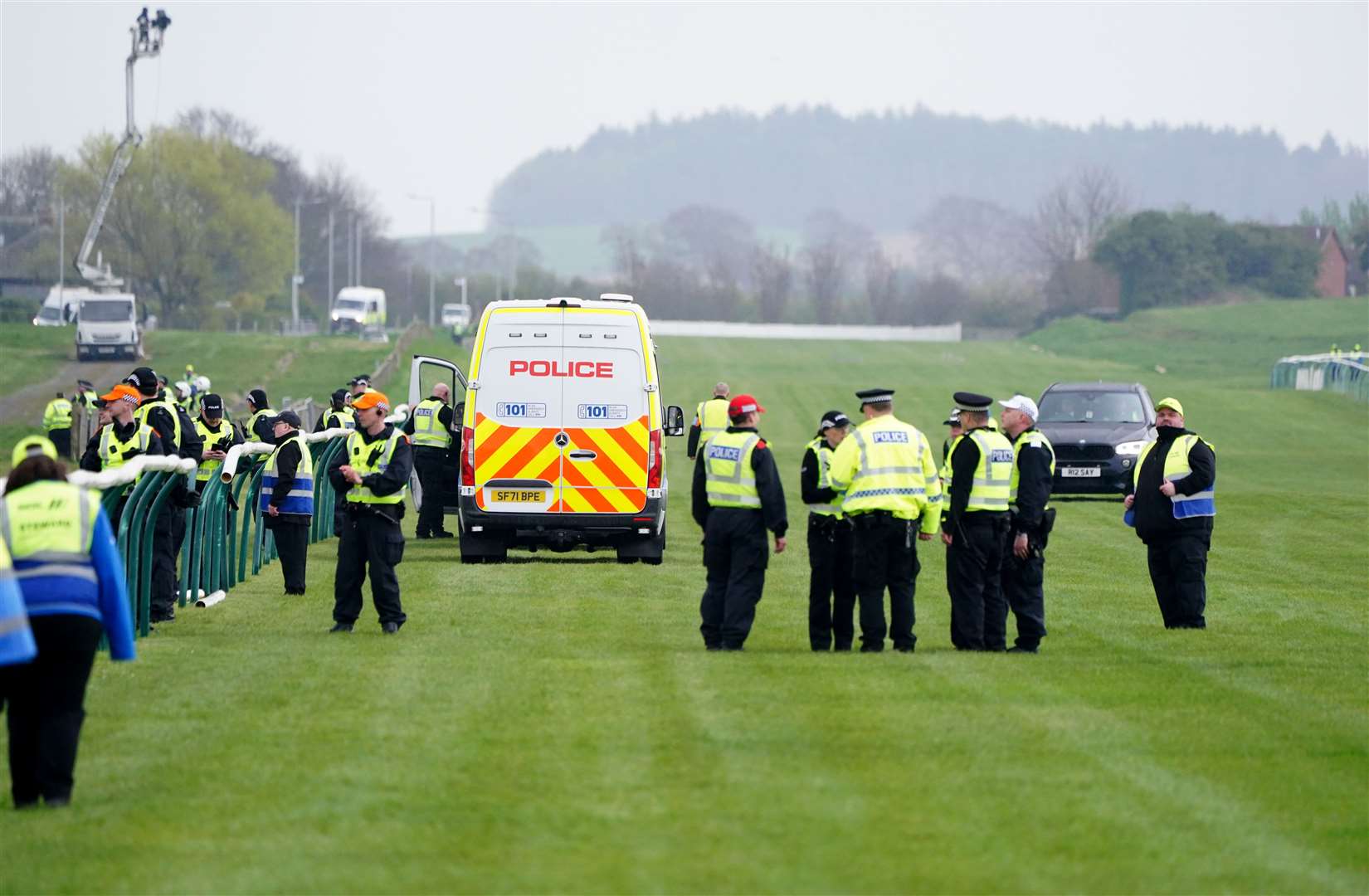 Police officers on the course after Animal Rising activists had to be removed from the track during the Coral Scottish Grand National festival at Ayr Racecourse in April (PA)
