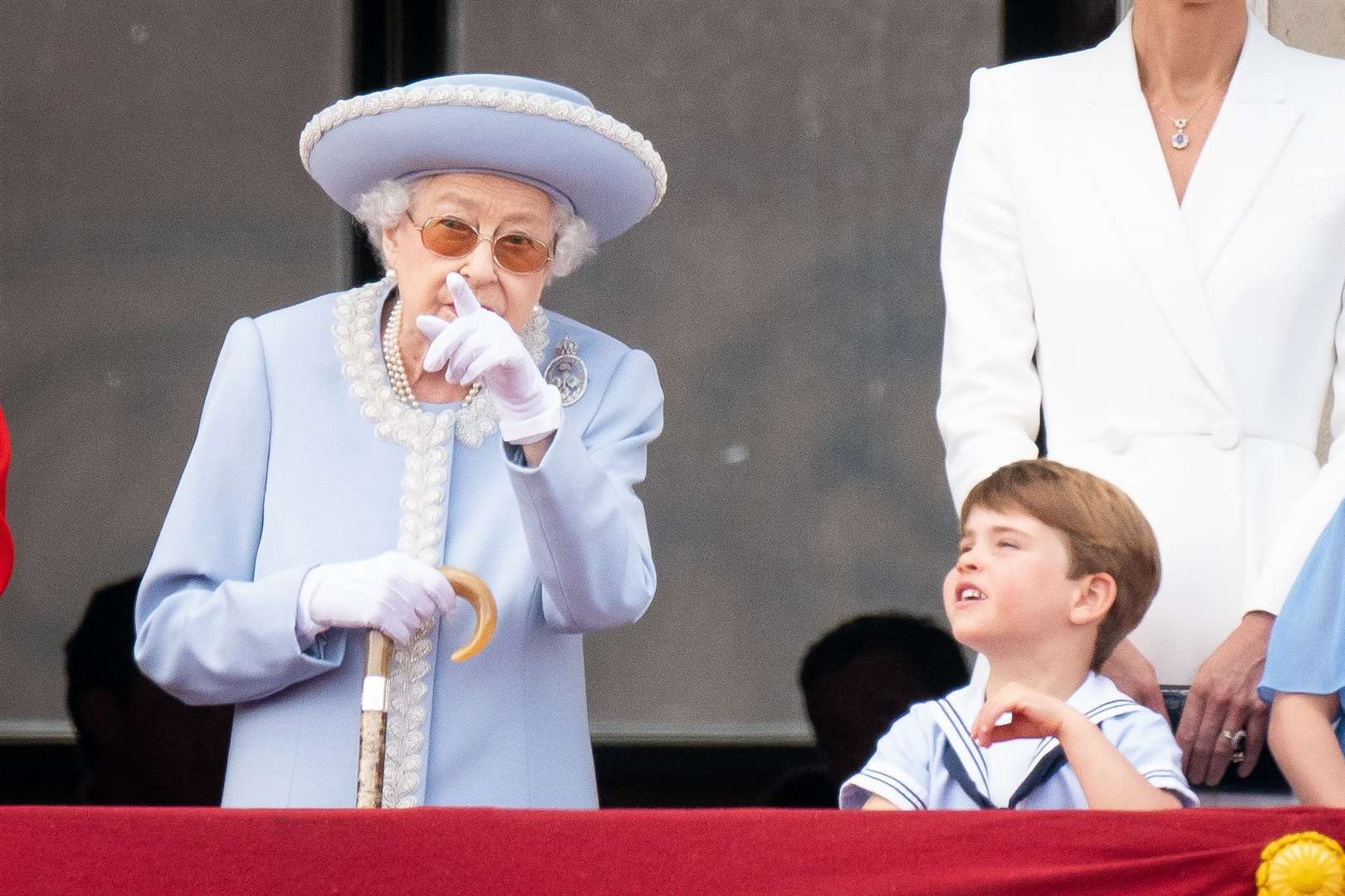 The Queen speaks to Prince Louis on the balcony of Buckingham Palace as they watch the flypast on day one of the Platinum Jubilee celebrations (Aaron Chown/PA)