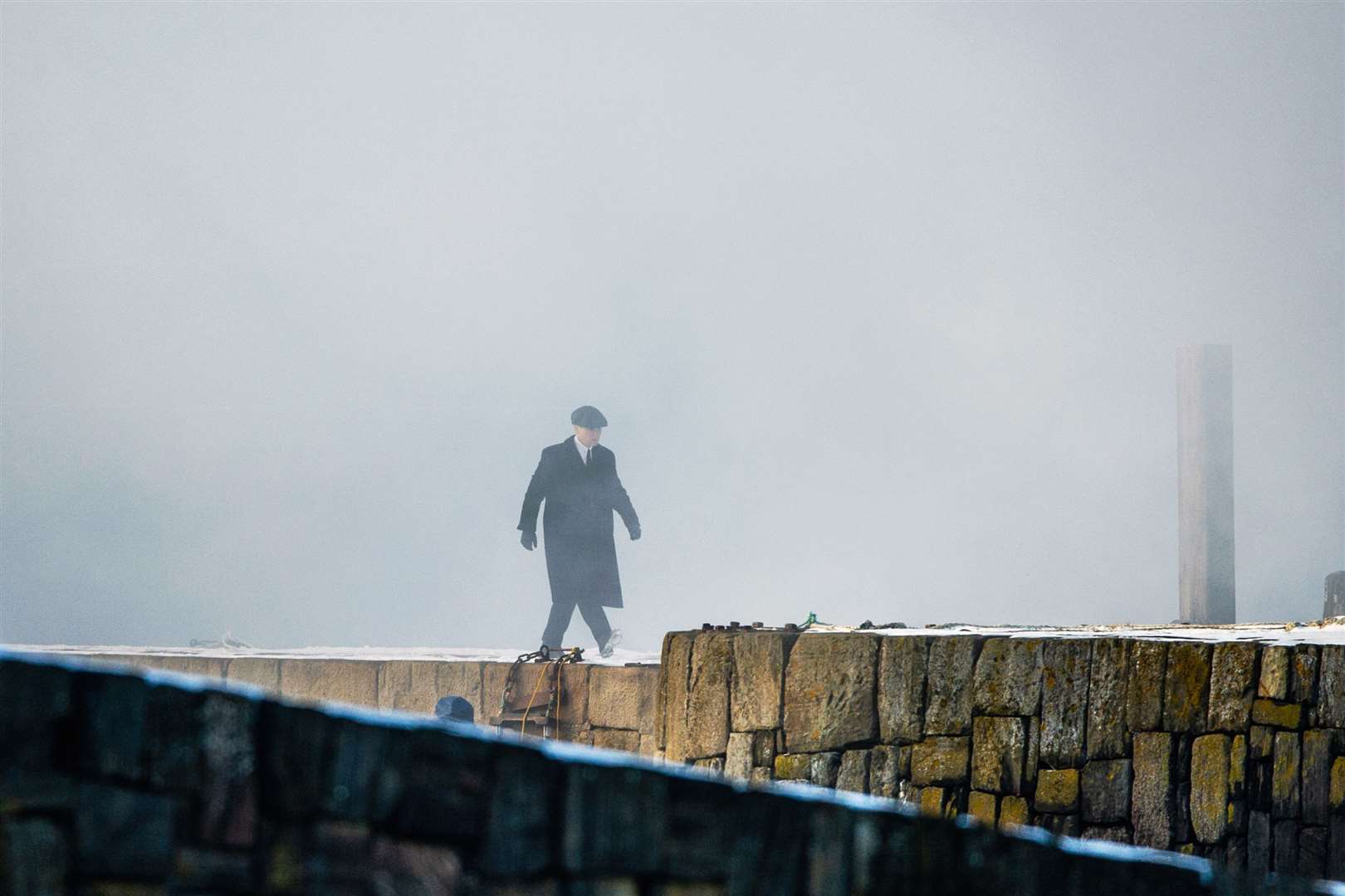 Tommy Shelby, who is played by Cillian Murphy, walks along Portsoy's old harbour pier. Picture: Daniel Forsyth..