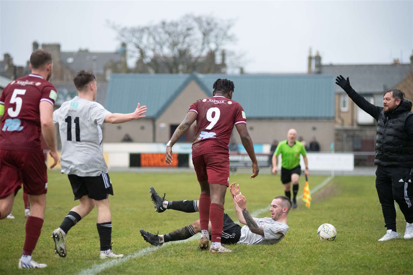 Keith forward Demilade Yunus barges Deveronvale's Zane Laird to the ground...Keith FC (1) vs Deveronvale FC (1) - Highland Football League 22/23 - Kynoch Park, Keith 04/02/23...Picture: Daniel Forsyth..