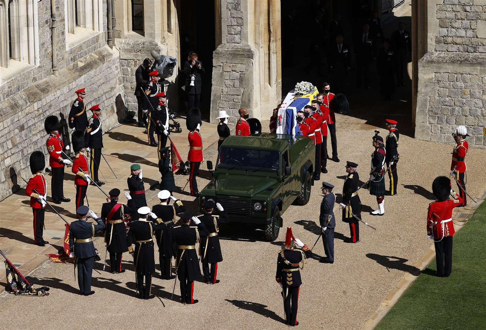 The Duke of Edinburgh’s coffin, covered with Personal Standard, is carried to the purpose-built Land Rover Defender (Adrian Dennis/PA)