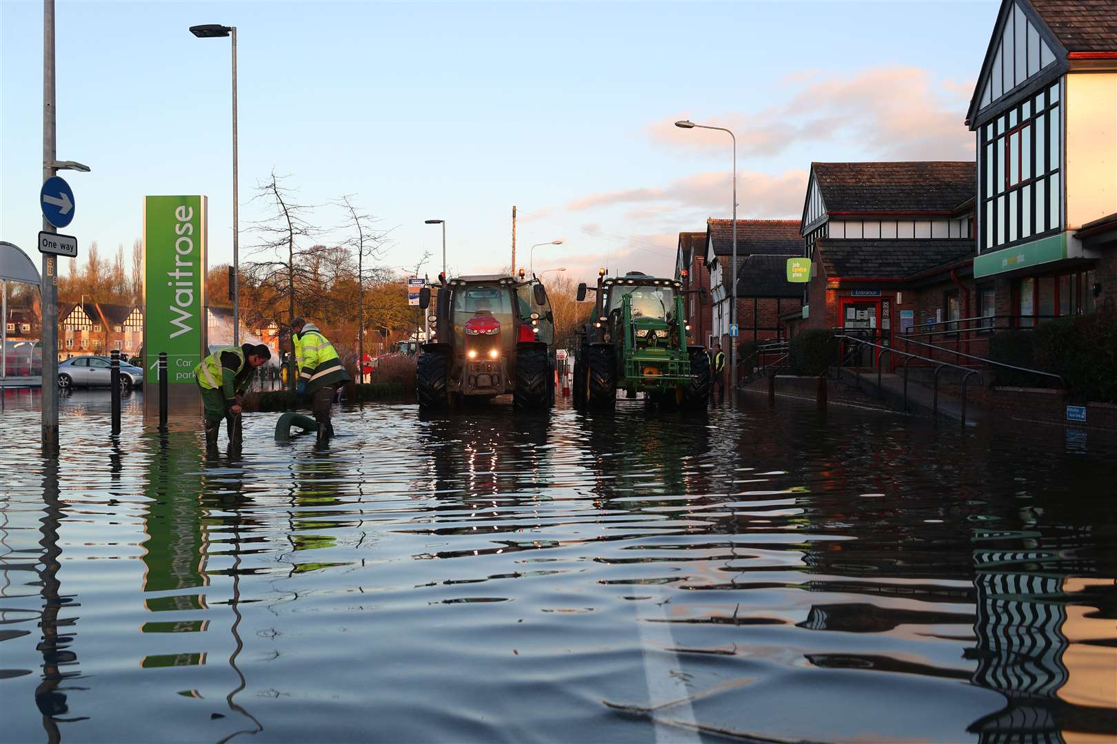 Workmen clear floodwater from in Northwich, Cheshire (Peter Byrne/PA)