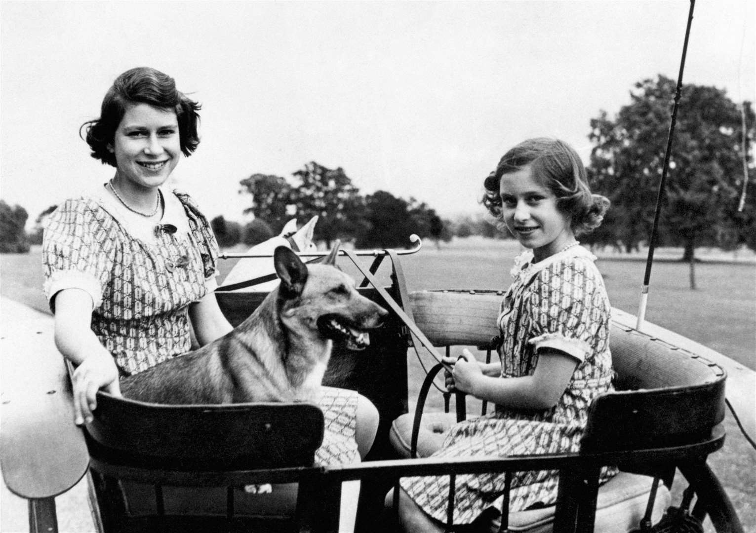 Princess Elizabeth and Princess Margaret in the garden at Windsor during the war (PA)