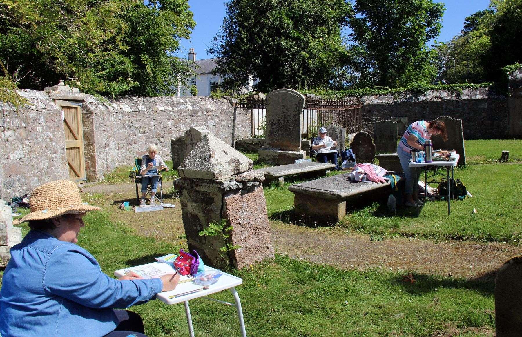 Christine Legge, Tina Fleming, Ray Dyson and Brenda Phimister outside the Auld Kirk during last year's Cullen Big Community Paint Out. Picture: Lyn MacDonald