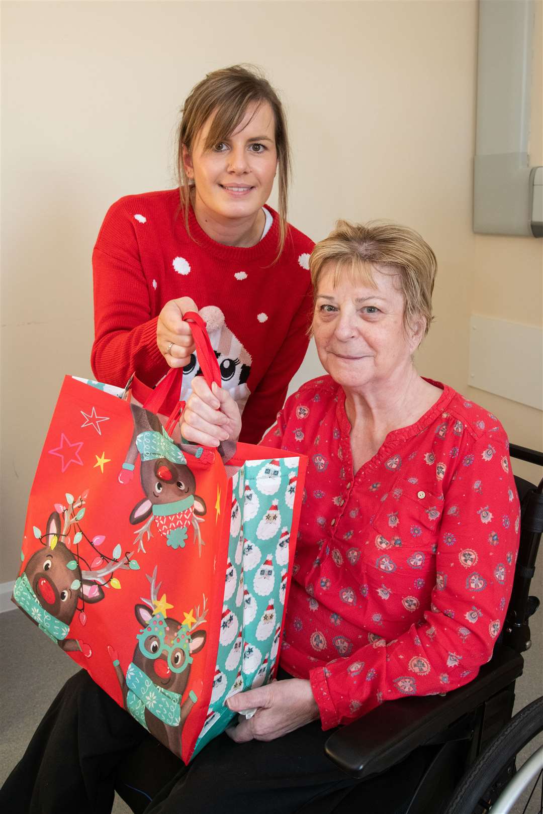 Megan Walls hands over a gift to patient Linda. Picture: Daniel Forsyth