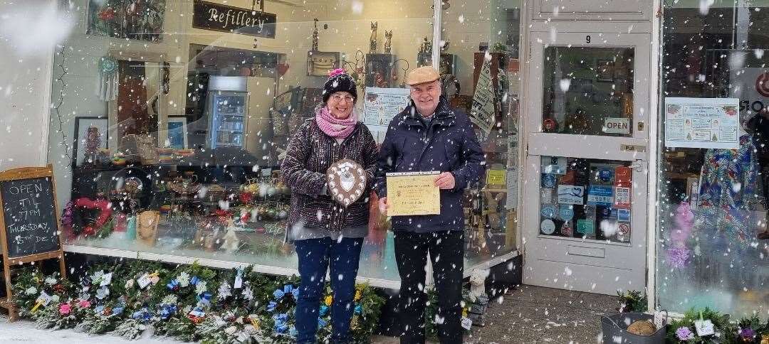 Ellie Turner of the Ethical Gift Shop on Duke Street, Huntly, accepting the award for best window from Tony Gill of Huntly Community Council.