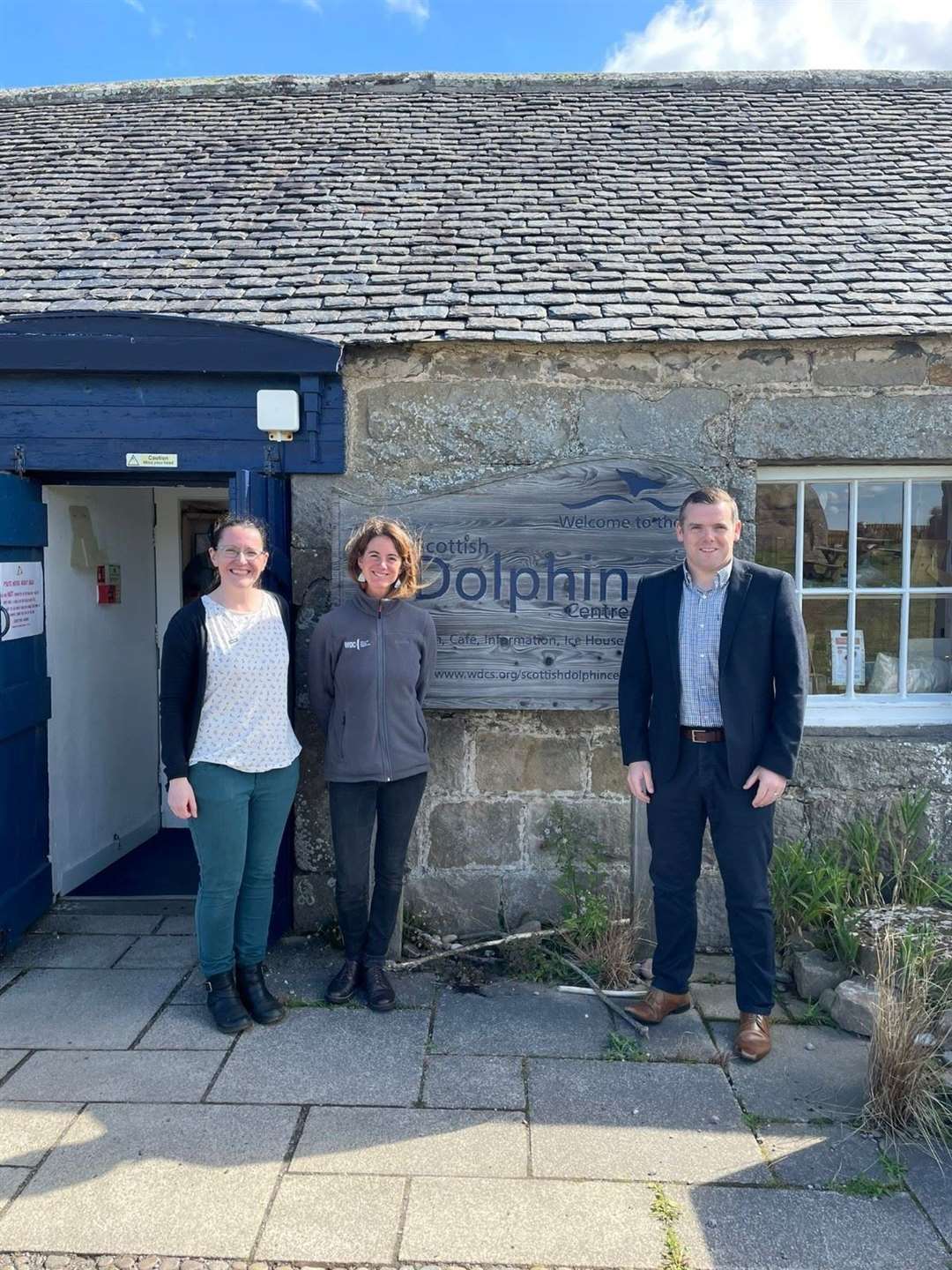 Alison Rose and Katie Dyke from the Scottish Dolphin Centre with Douglas Ross.