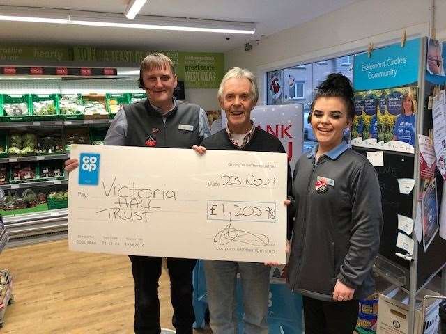Victoria Hall Trust’s Keith Hart (middle) being presented with a cheque by store manager Dean Knox and Co-op colleague Tanya Slesser.