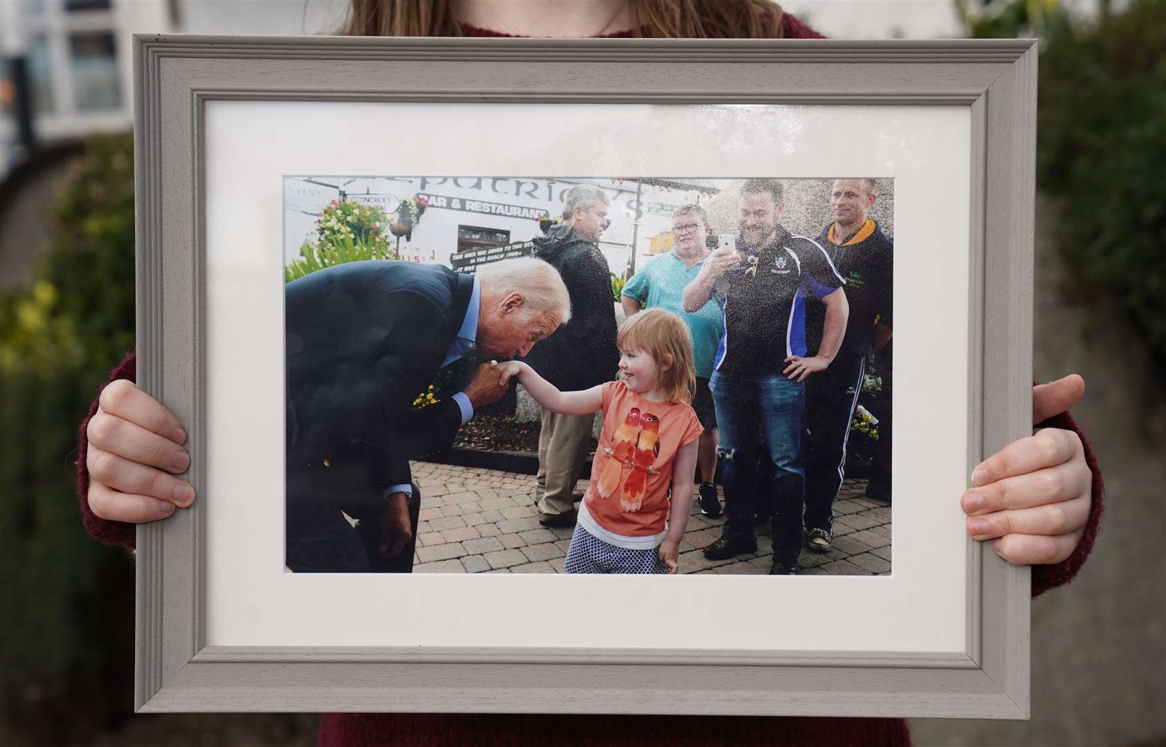 A photograph of Joe Biden kissing Aoibhinn Brennan’s hand in 2016 (Brian Lawless/PA)