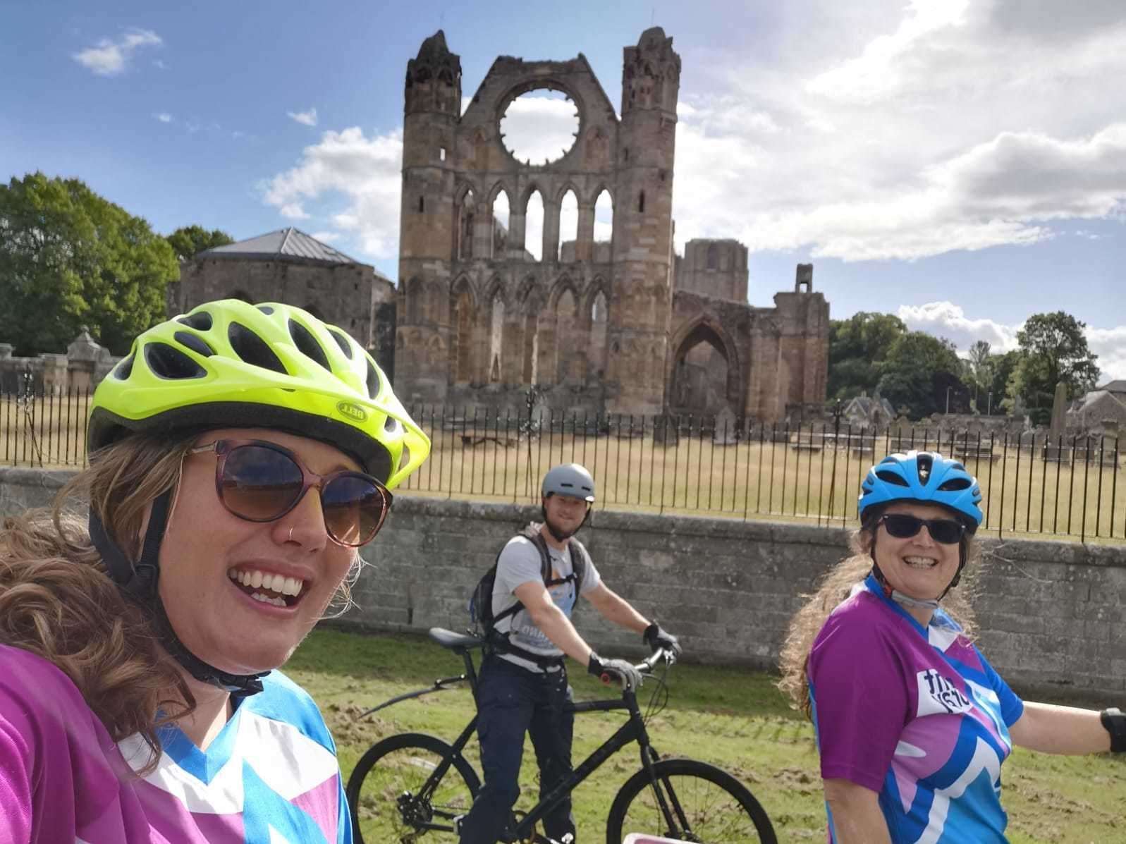 Outfit Moray staff (from left) Anna Vince, Andy Woolnough and Karen Cox, on their bikes outside Elgin Cathedral.
