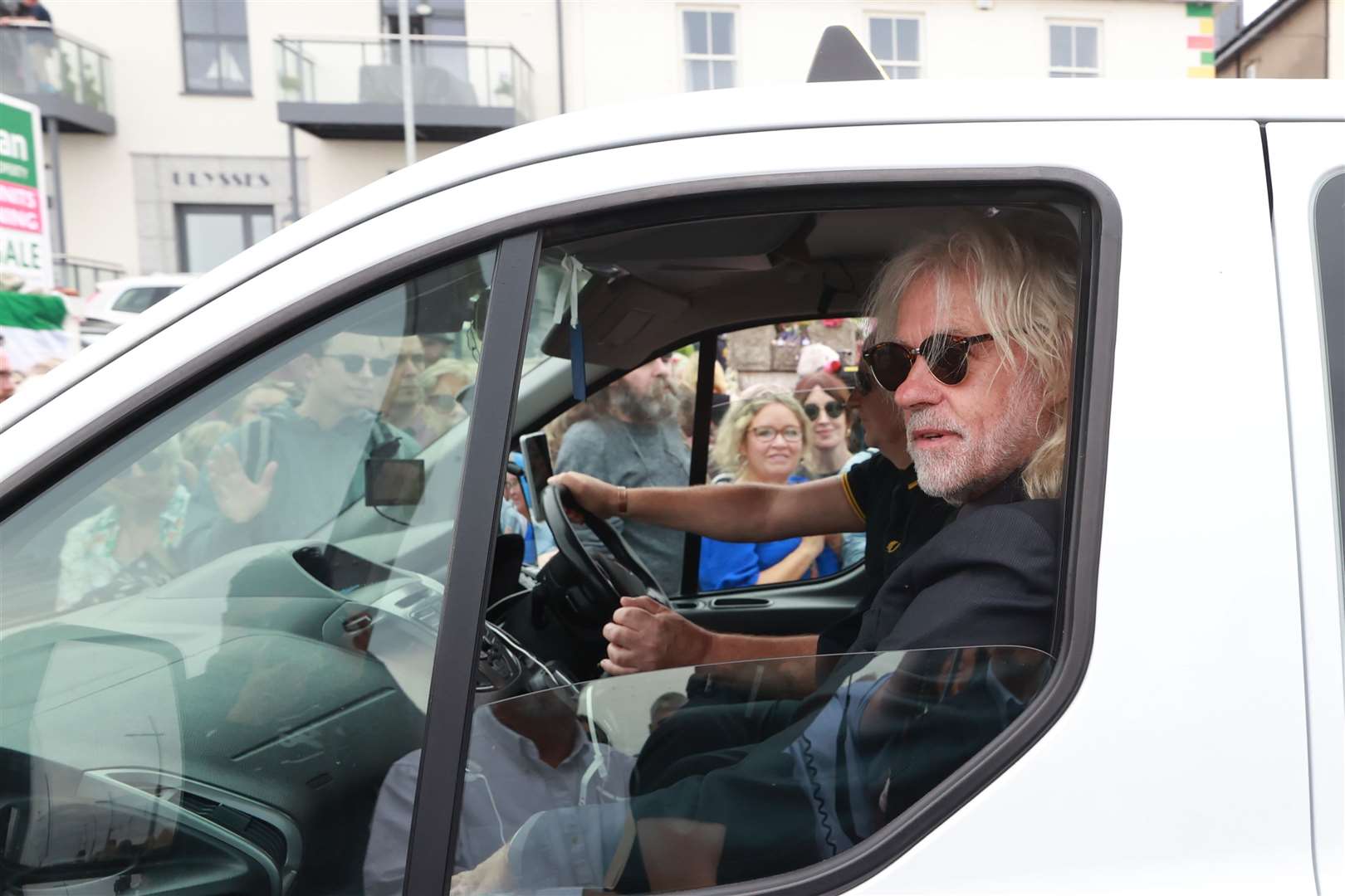 Bob Geldof rides in a taxi as part of the funeral cortege for Sinead O’Connor as the procession passes through Bray, Co Wicklow (Liam McBurney/PA)
