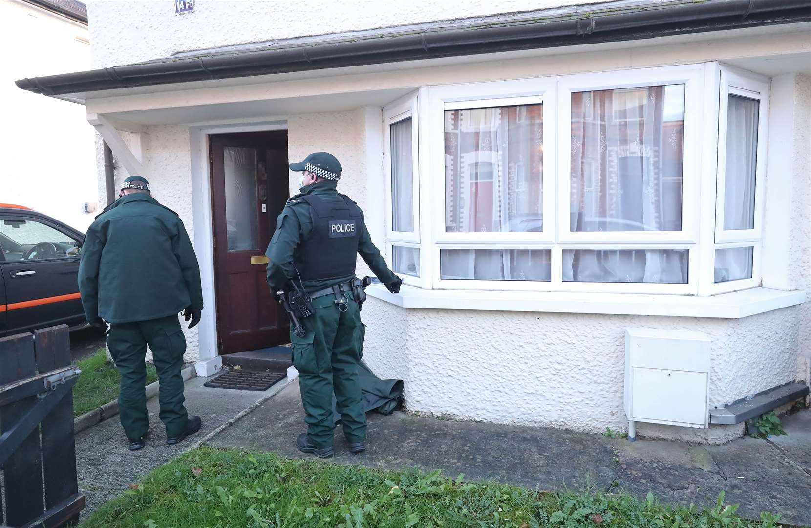 Police search a property in south Belfast in connection with the bombings investigation (Niall Carson/PA)
