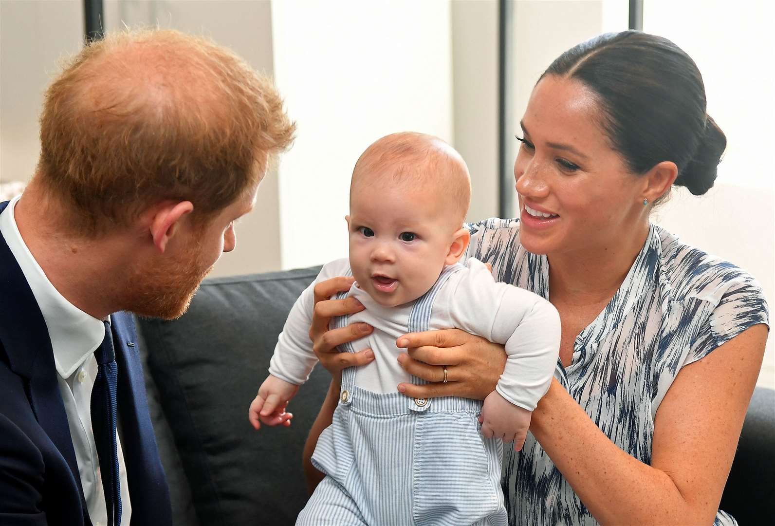 Harry and Meghan holding their son Archie during a meeting with Archbishop Desmond Tutu in 2019 (Toby Melville/PA)