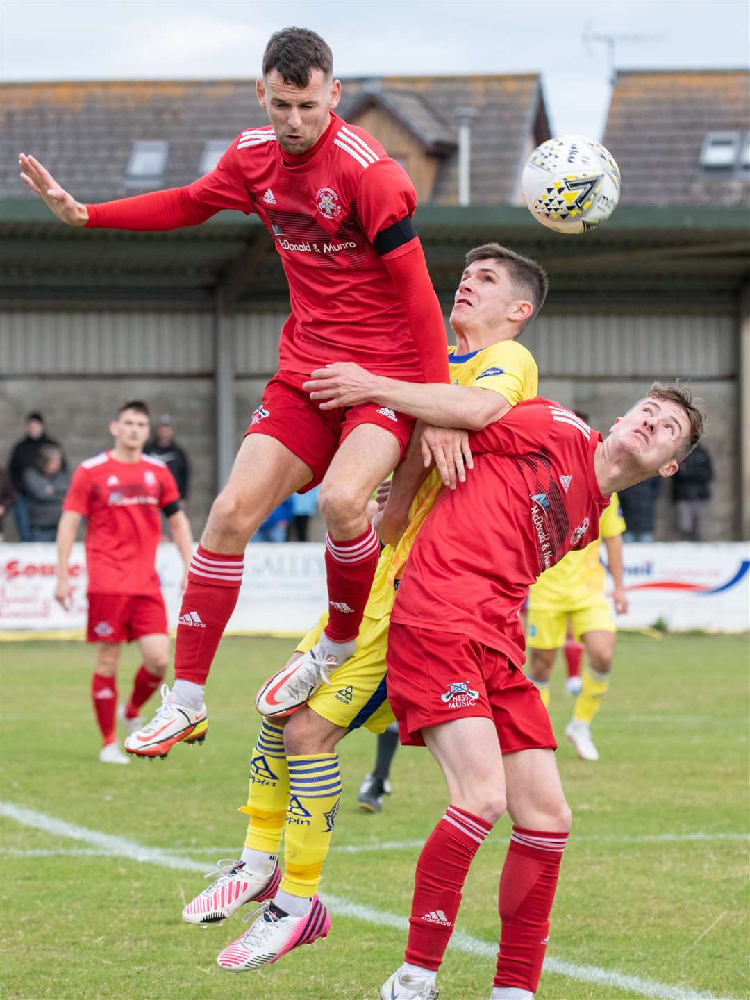 Buckie's Marcus Goodall is stuck in a Lossiemouth sandwich between Ryan Farquhar (left) and Ross Morrison. Picture: Daniel Forsyth..