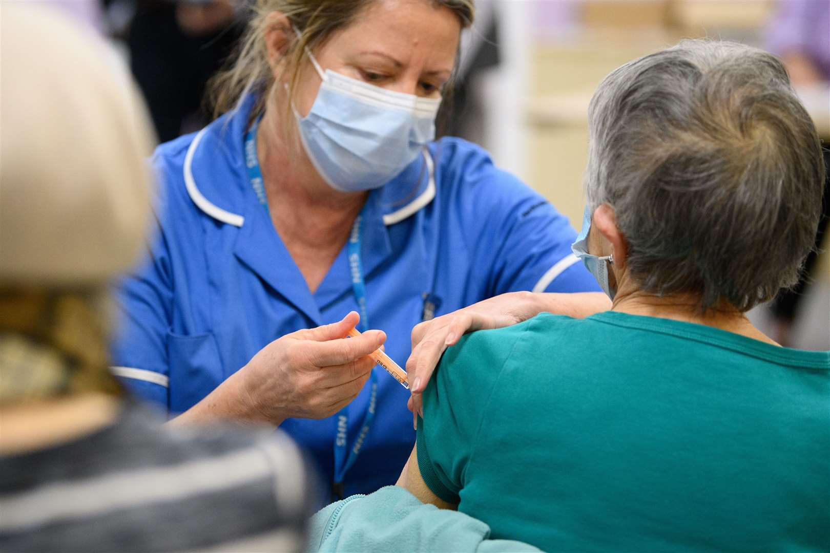 A member of a medical team administers a Covid-19 vaccine injection (PA)