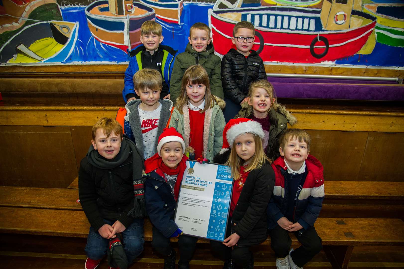 Findochty Primary's P1/2 kids proudly show off the school's gold UNICEF Rights Respecting School Award. Picture: Becky Saunderson