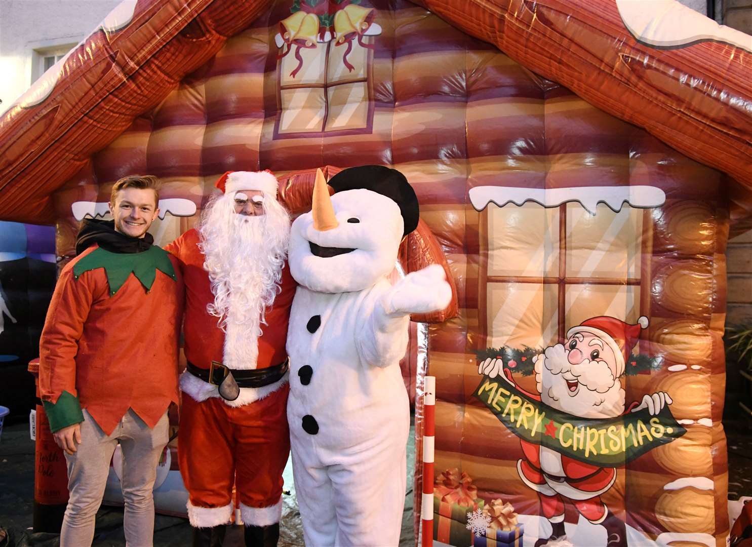 Rogan Read (left) with Santa and the snowman outside the Grotto at the Christmas Cracker. ..Banff Christmas Cracker, 2022...Picture: Beth Taylor.