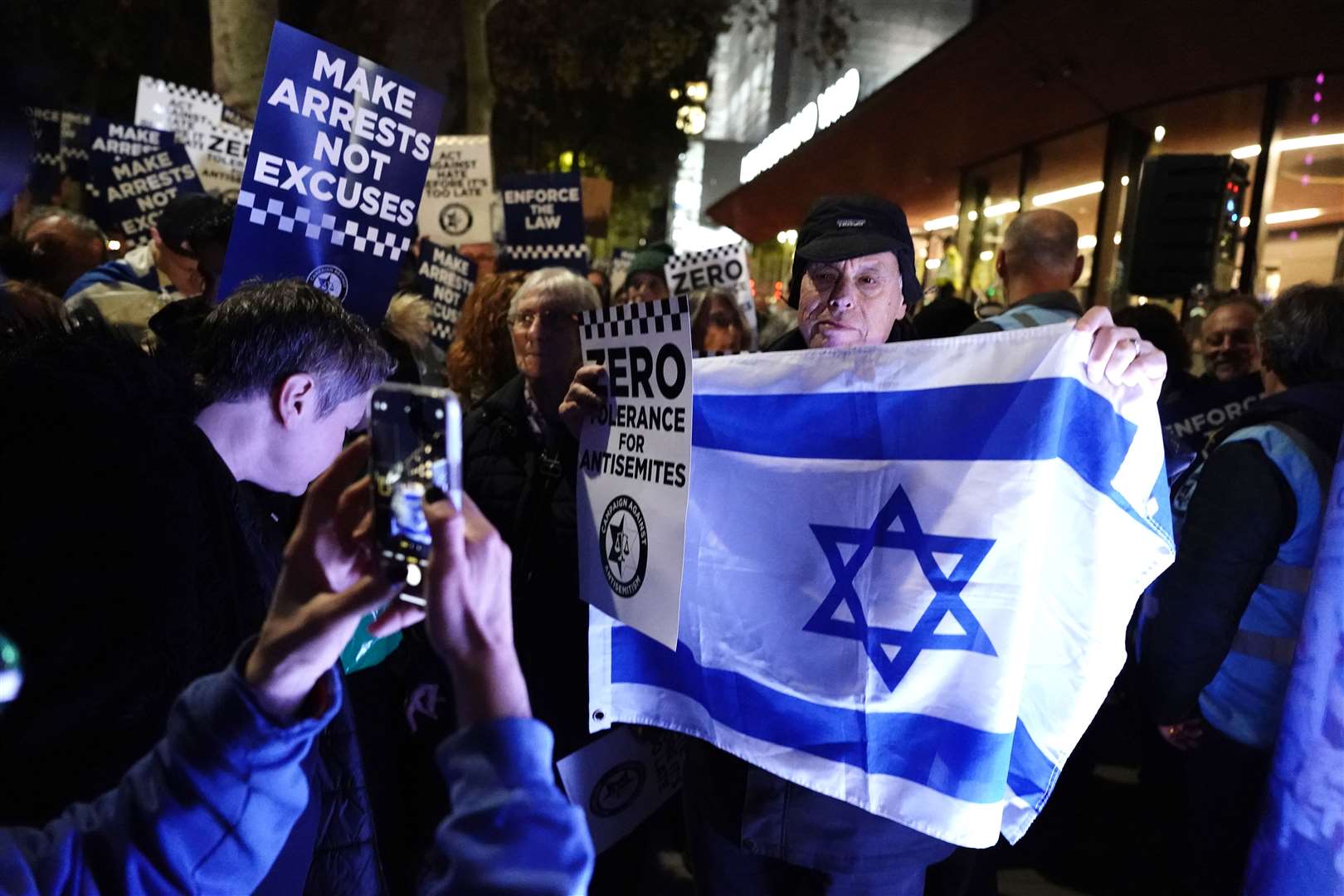 A campaigner holds up an Israeli flag during the protest (Jordan Pettitt/PA)