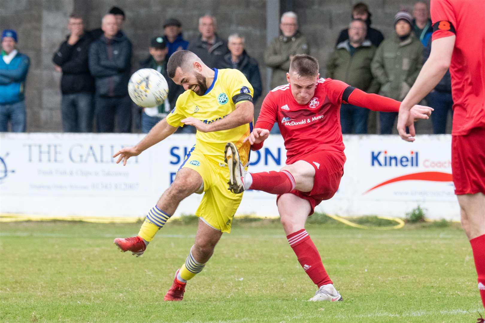 Lossie centre back James Leslie clears the ball away from Jags Andy Macaskill. Picture: Daniel Forsyth
