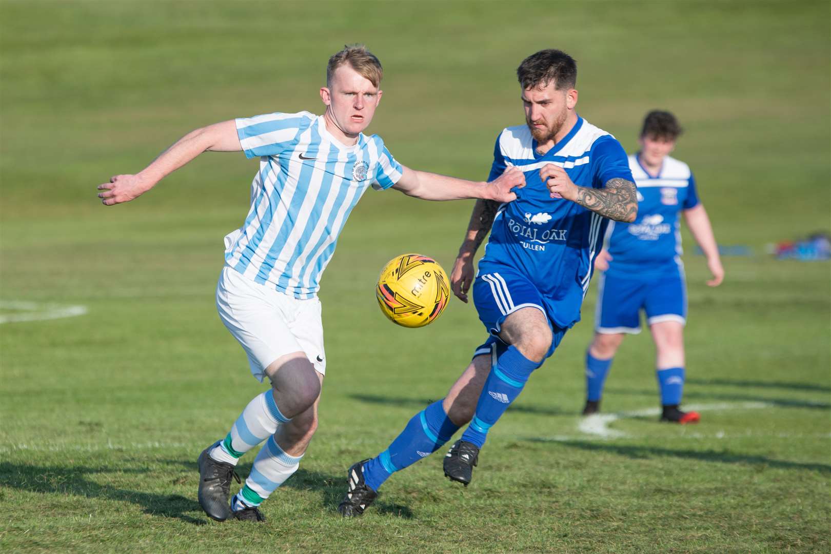 Cullen's Keiran Riddoch keeps a close eye on RAF Lossiemouth's Harry Williams. Picture: Daniel Forsyth