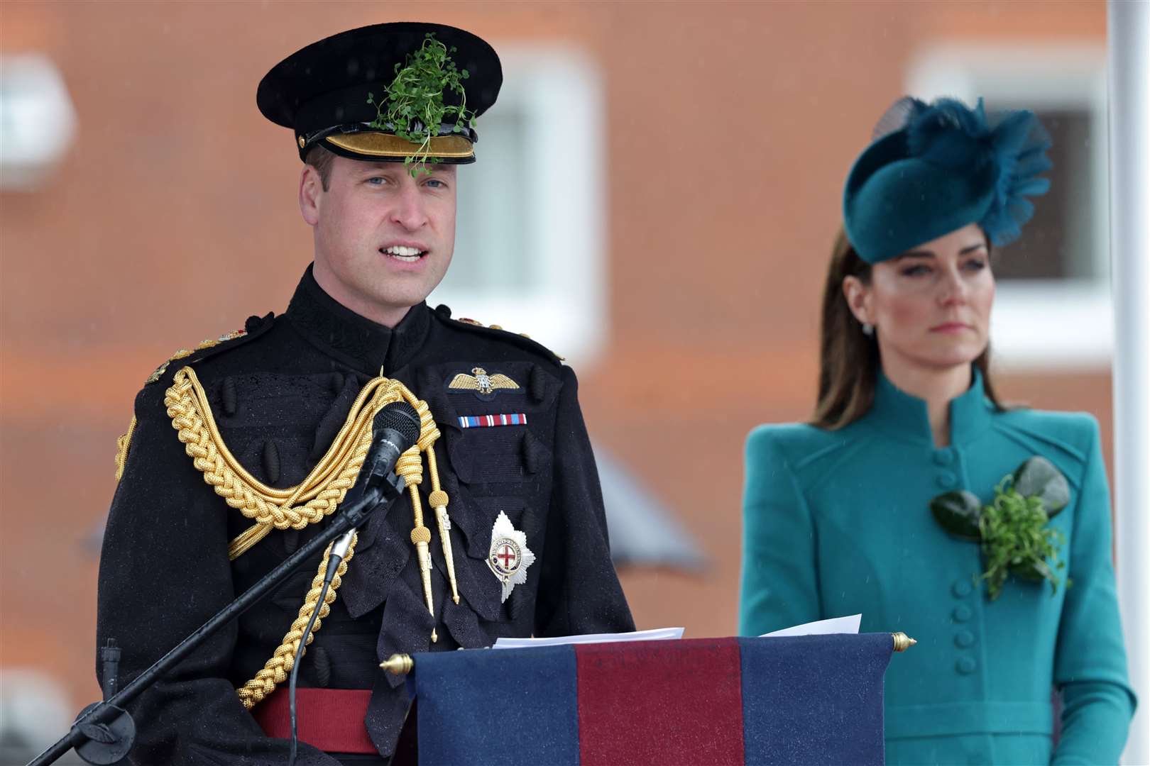 The Prince of Wales speaks on stage with the Princess of Wales during a visit to the 1st Battalion Irish Guards at Mons Barracks in Aldershot (Chris Jackson/PA)