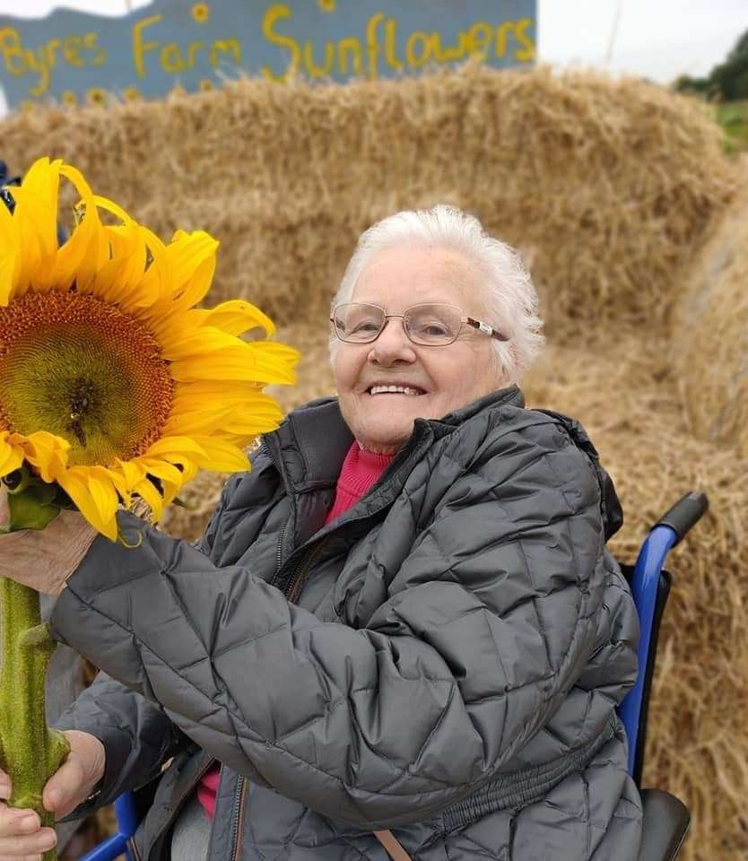 Jane Ann Smith with a giant sunflower.