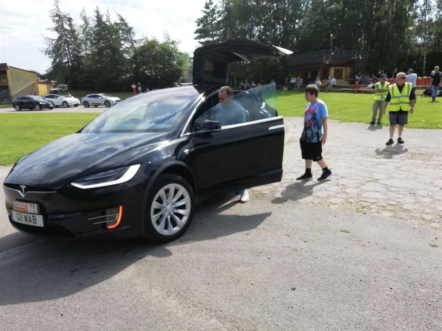 A hi-tech Tesla Model X welcomes passengers through unique gull-wing rear doors