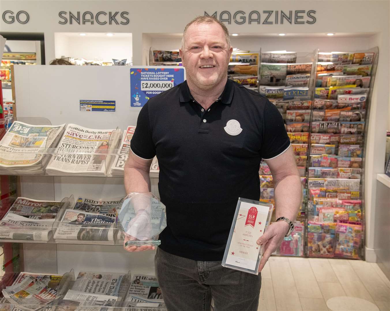 Feeling just champion...David Robertson proudly shows off his UK and Scottish Retailer of the Year Awards. Picture: Beth Taylor
