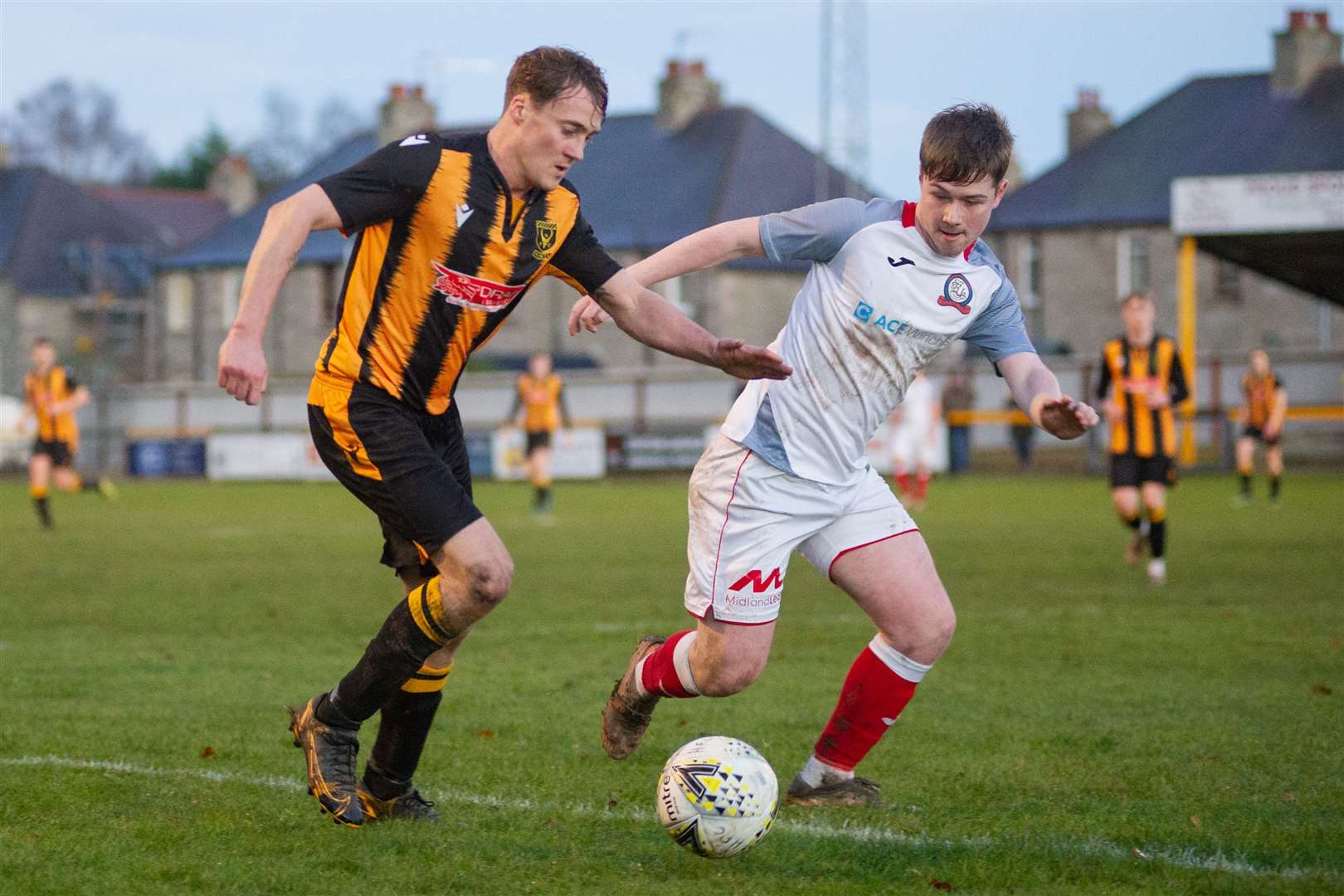 Huntly's Gavin Elphinstone (left) and Turriff's Rhys Clark (right) in action. Picture: Daniel Forsyth..