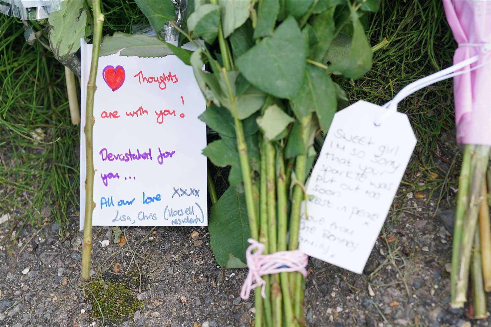 A note left on flowers outside a property on Hammond Road (Jonathan Brady/PA)