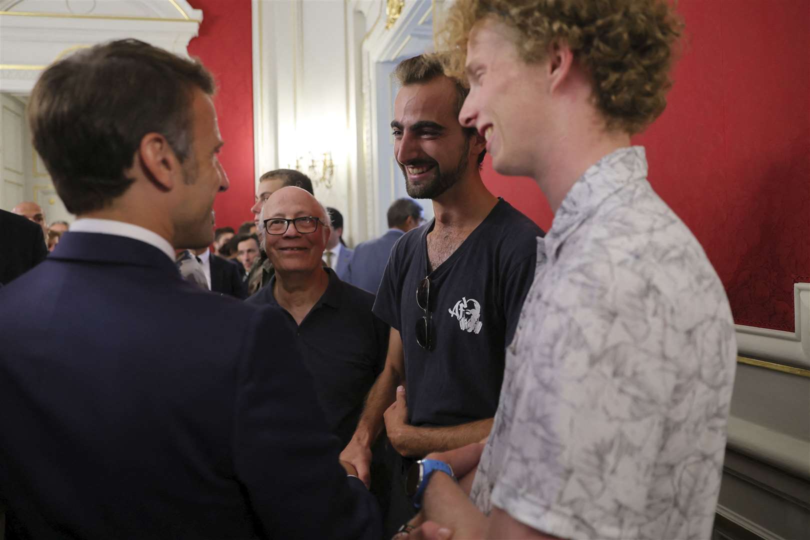 French President Emmanuel Macron meets Henri, second right, the 24-year-old ‘backpack hero’ (Denis Balibouse/Pool via AP)