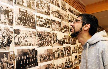 Abid Ali, who is on work experience at the Banffshire Advertiser, looks at some of the old photos. Photo: Lyn MacDonald