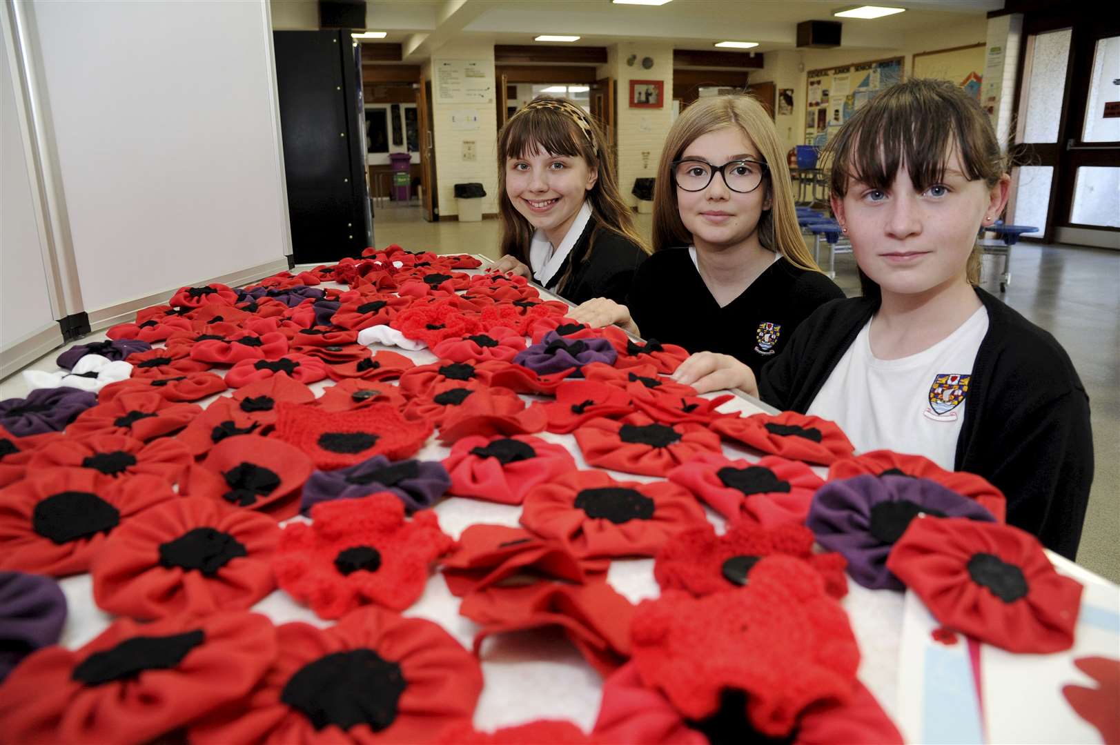 Admiring the school's poppy-making efforts are (from left) Sara McCormack, Erwin Mitchell and Maya Cormack. Picture: Eric Cormack.